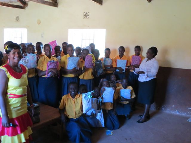 students holding kits inside classroom