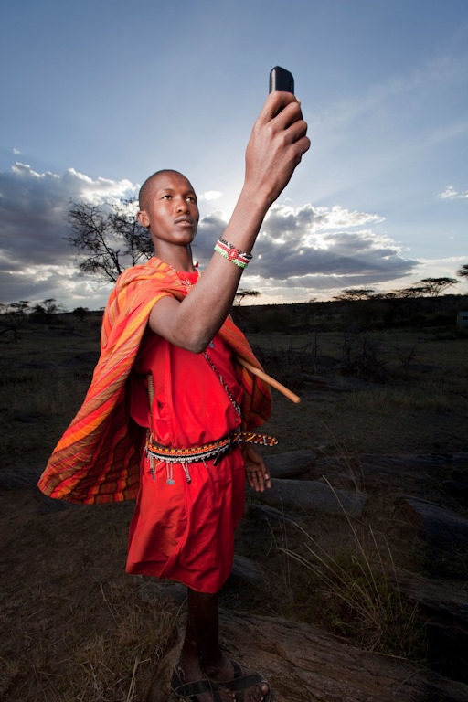 African man holding a cell phone