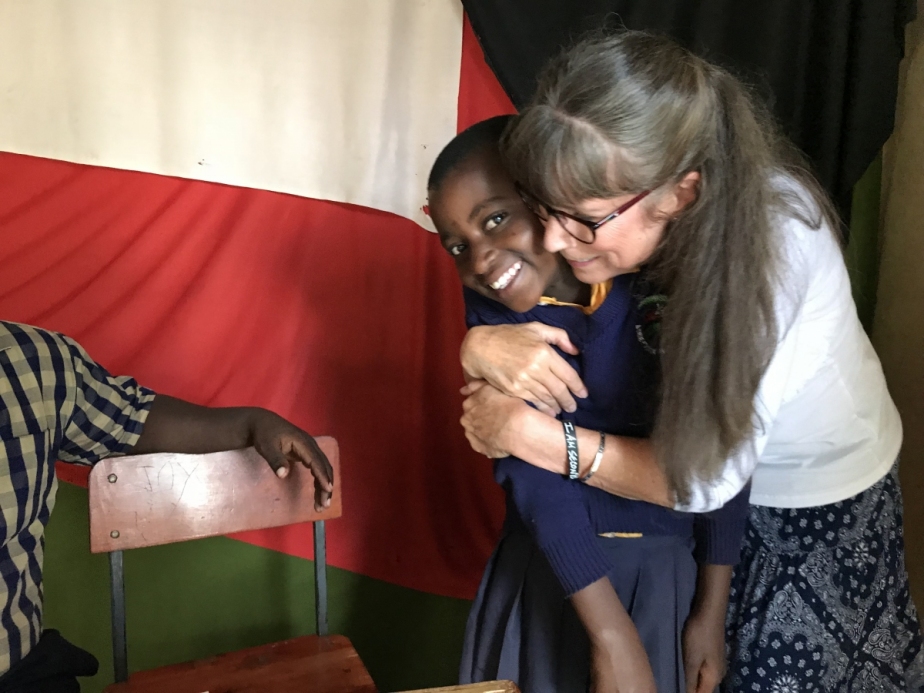 Brooks hugging a smiling African girl