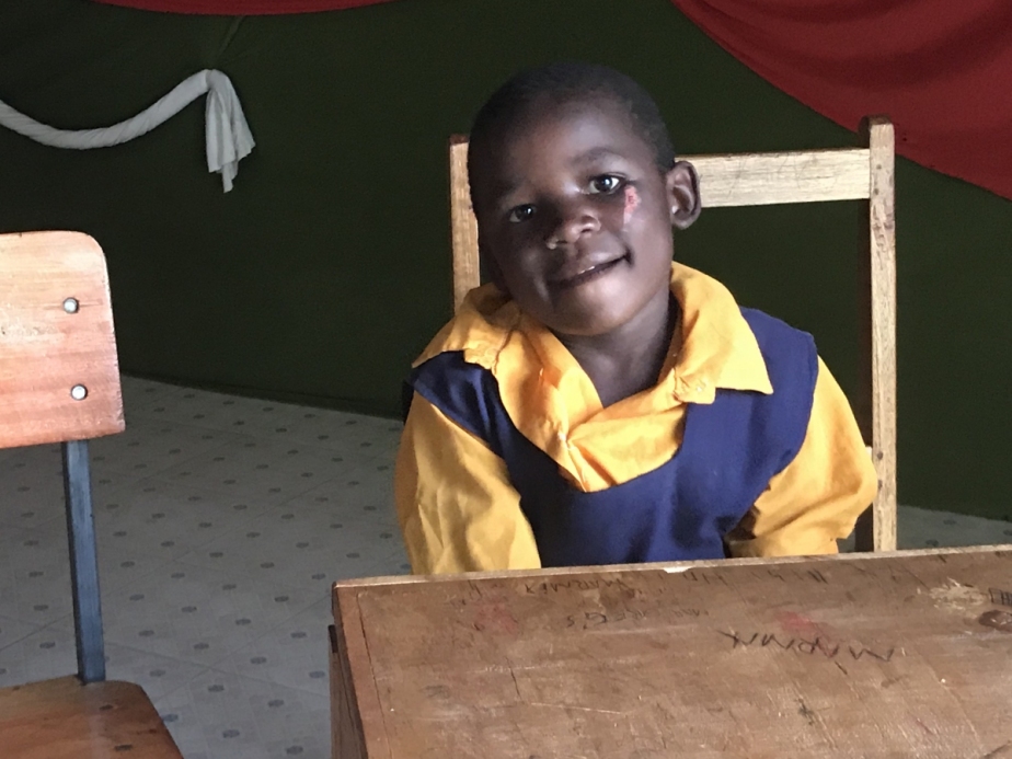 smiling boy in Liberty School uniform