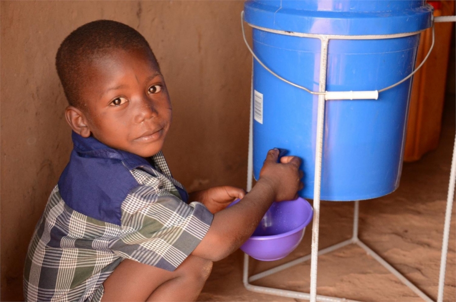 a young boy using a water filter
